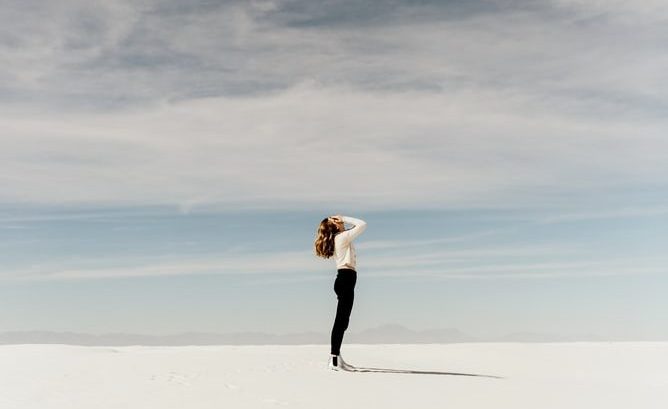 Woman breathing in ocean air on beach