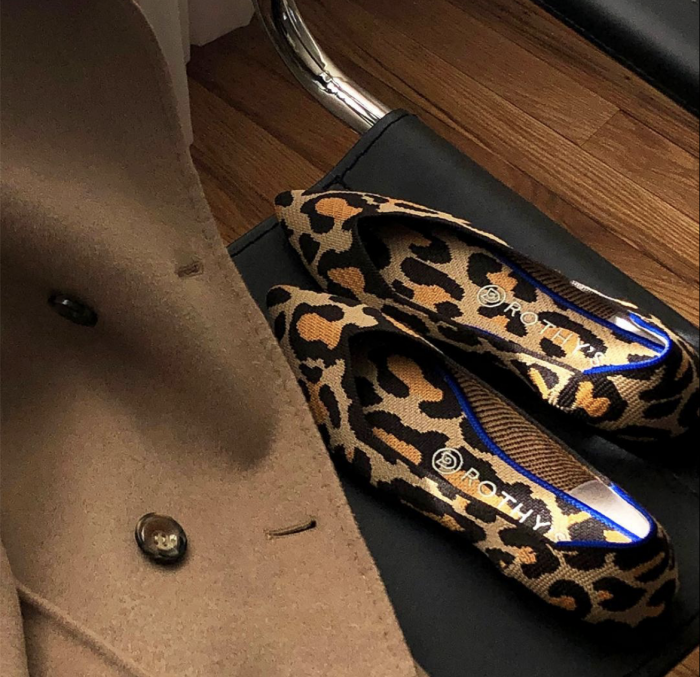 Rothys leopard flats laying next to camel coat