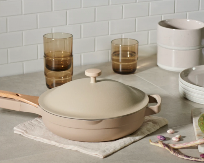 beige always pan from our place sitting on light quartz counters surrounded by dishware